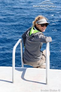 Young woman sitting on the edge of a boat